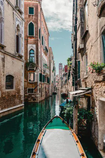 A boat is in the water near some buildings.