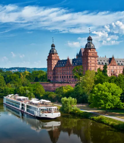 A large boat on the water near some buildings.