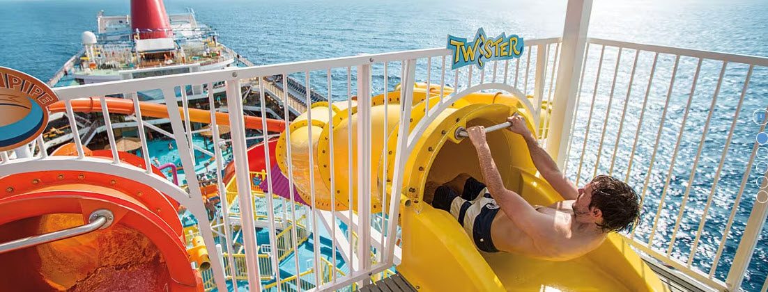 A person riding down the side of a water slide.