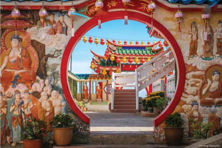 A red and white circular doorway with steps leading to it.