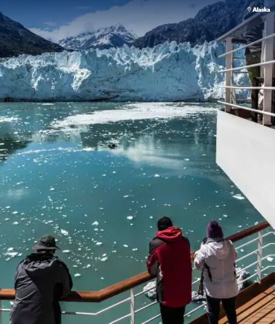 Three people on a boat looking at the ice