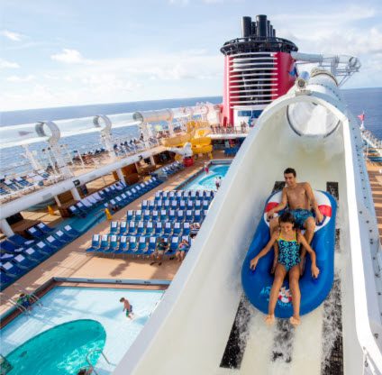 A family rides down the water slide on board a cruise ship.