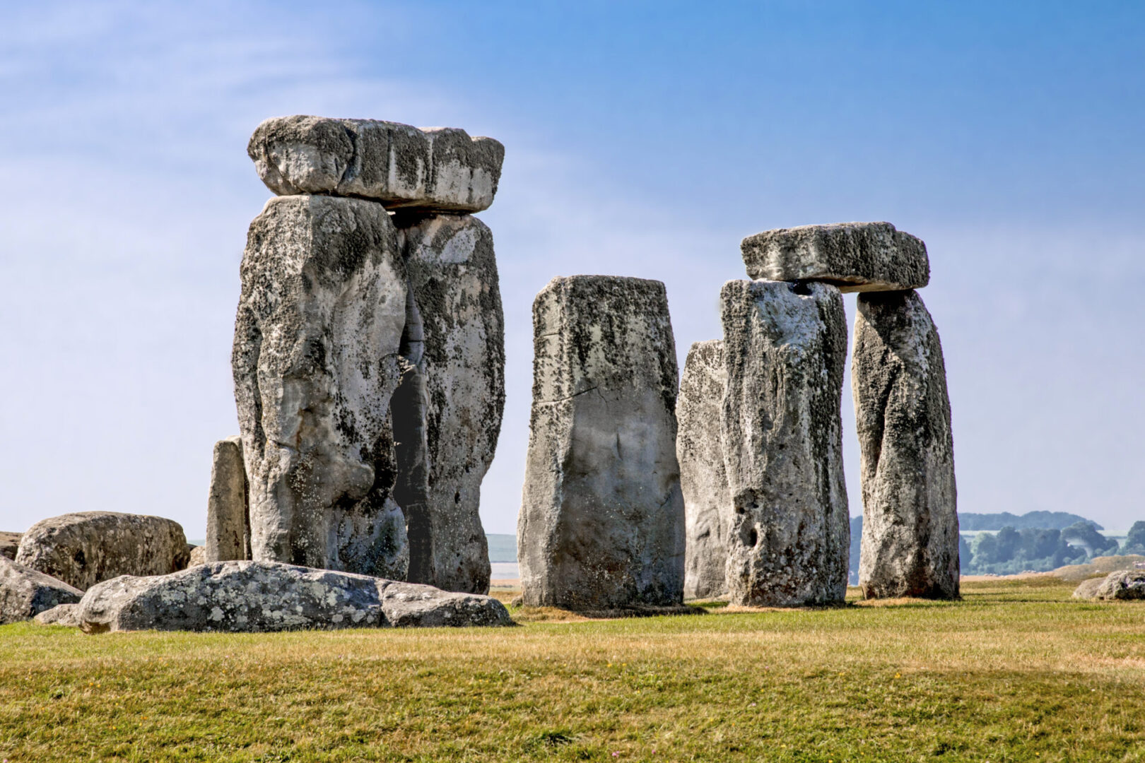 A group of large stone pillars in the grass.