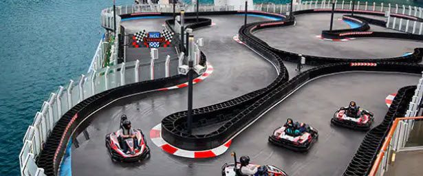 A group of people riding on the back of toy cars.