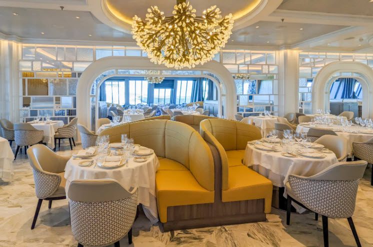 A restaurant with tables and chairs, and a chandelier.