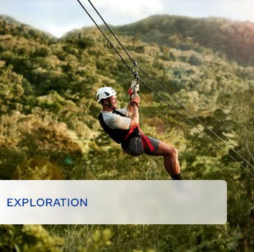 A man riding on the side of a rope swing.