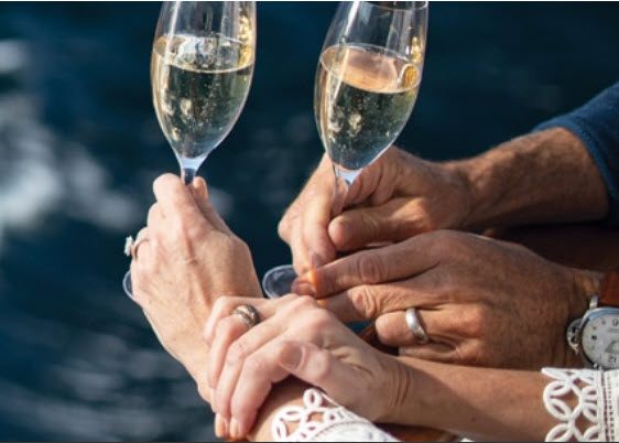 A group of people holding champagne flutes in their hands.