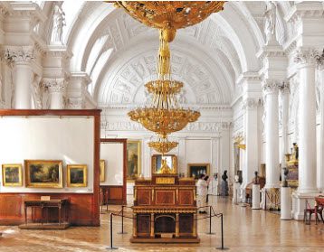 A large room with many paintings on the walls