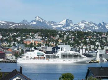 A large cruise ship in the middle of a city.