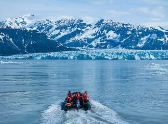 A boat with four people on it in the water.