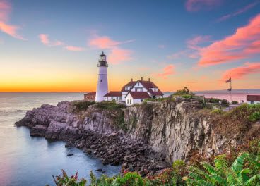 A lighthouse on the edge of an ocean.