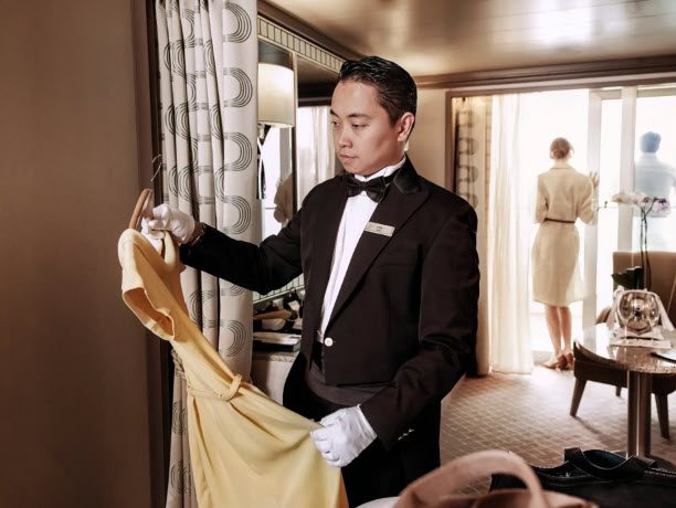 A man in a tuxedo holding onto a yellow dress