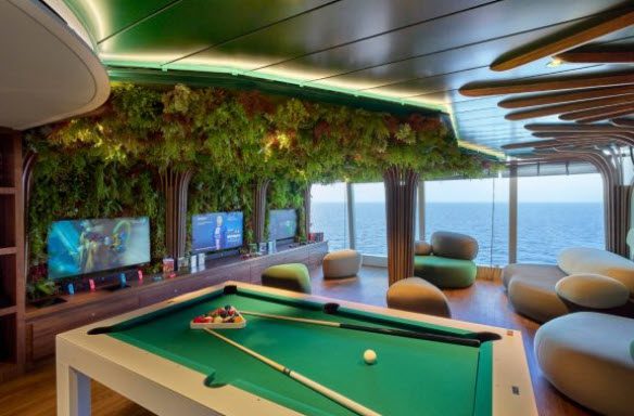 Pool table in a green and blue room.